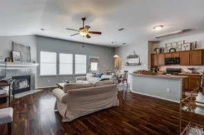 a living room with furniture a fireplace and a flat screen tv