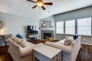 a living room with furniture a large window and a fireplace
