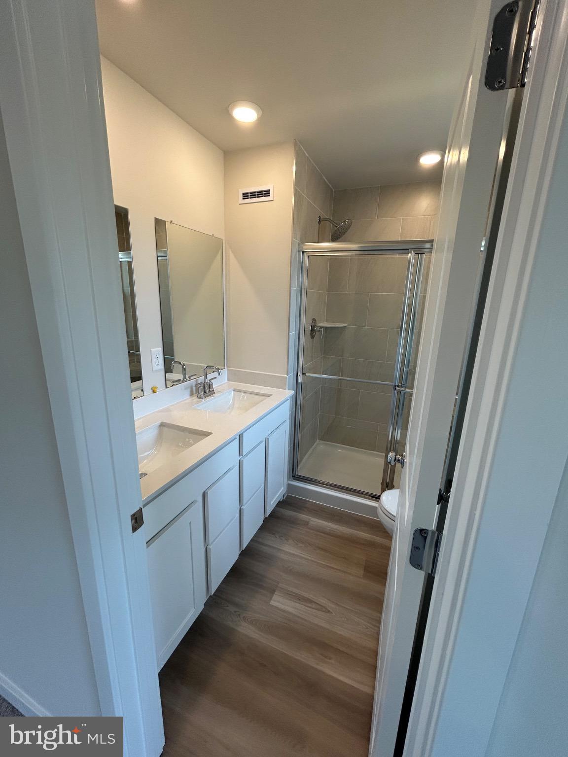 28 Barnes Way Sicklerville, NJ 08081 - Photo 27 of 40 a bathroom with a double vanity sink a mirror and a shower