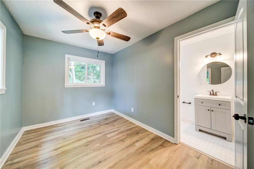 2951 Haralson Road Decatur, GA 30033 - Photo 12 of 25 a view of a bedroom with a chandelier fan and windows
