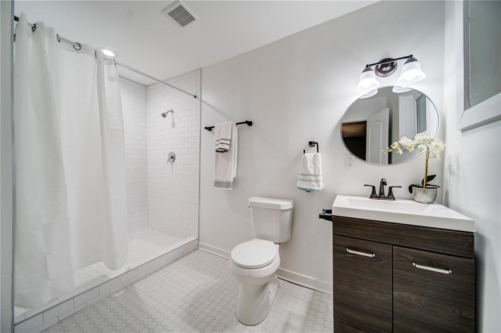 2951 Haralson Road Decatur, GA 30033 - Photo 19 of 25 a bathroom with a toilet a sink and mirror
