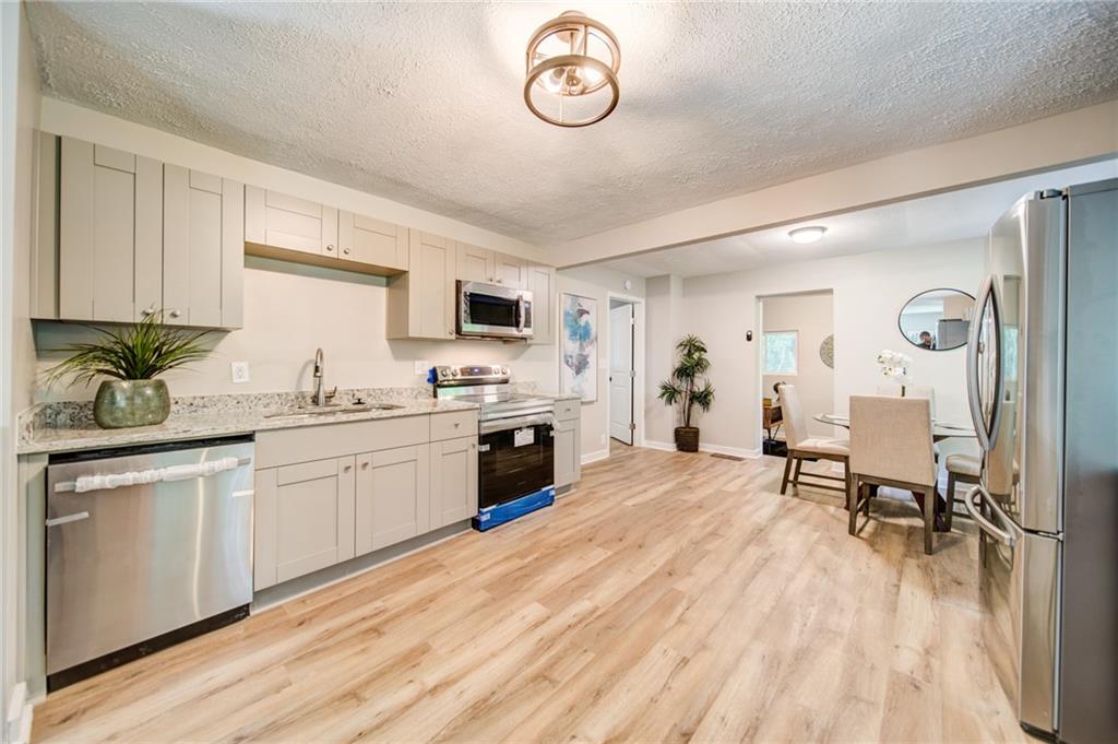 2951 Haralson Road Decatur, GA 30033 - Photo 4 of 25 a open kitchen with white cabinets and stainless steel appliances