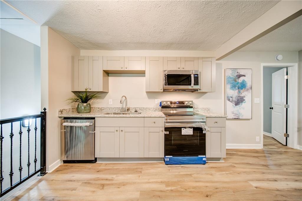 2951 Haralson Road Decatur, GA 30033 - Photo 6 of 25 a kitchen with stainless steel appliances a stove microwave and refrigerator