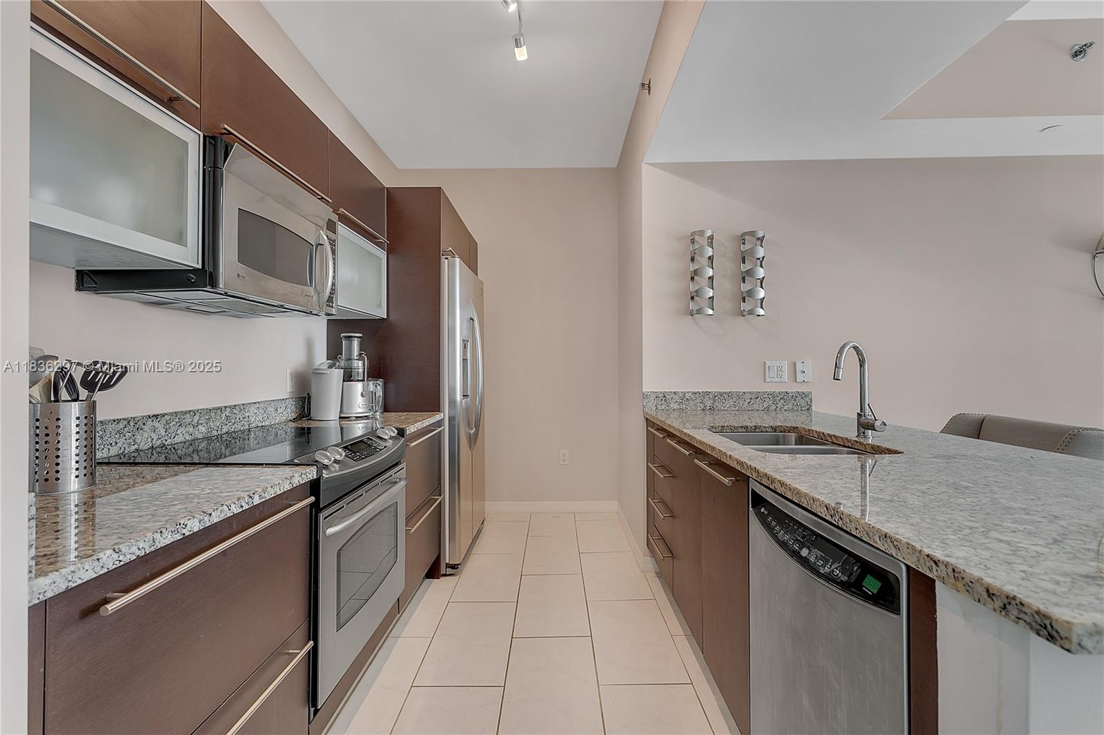 Brickell Miami, FL 33131 - Photo 2 of 17 a kitchen with stainless steel appliances granite countertop a sink and a stove