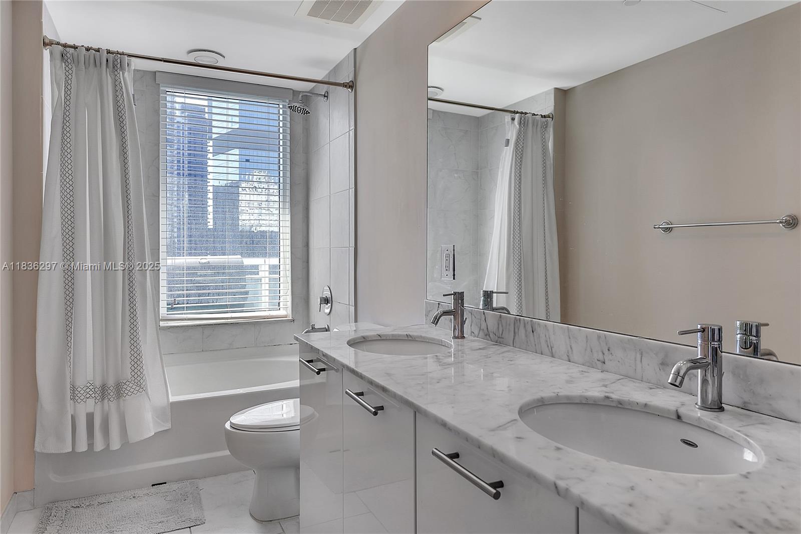 Brickell Miami, FL 33131 - Photo 7 of 17 a bathroom with a granite countertop sink toilet and shower