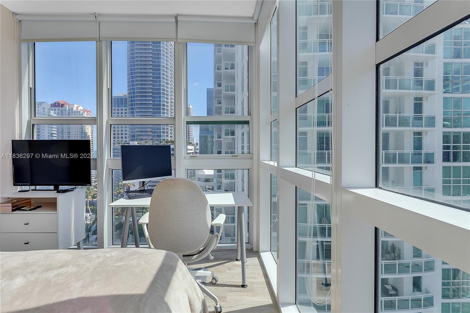 Brickell Miami, FL 33131 - Photo 9 of 17 a living room with furniture a flat screen tv and kitchen view