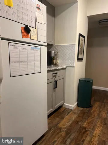a kitchen with a refrigerator and a stove