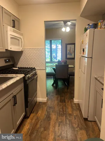 a kitchen with a refrigerator a stove top oven a sink and dishwasher