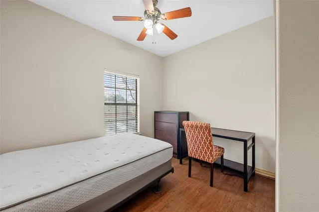 a bedroom with a bed chair and a window