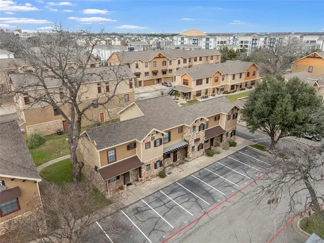 an aerial view of a house with a yard