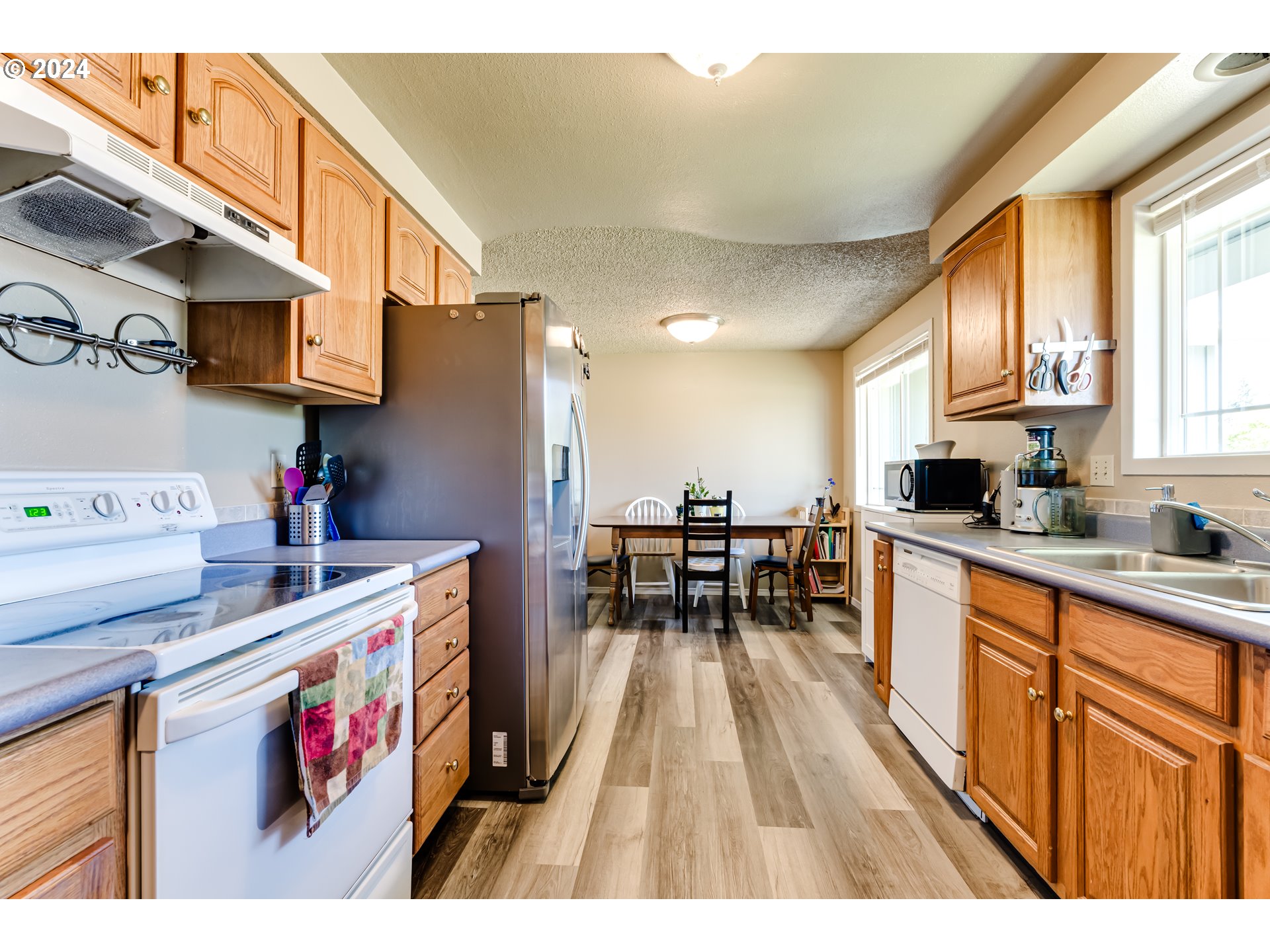 1048 Laurel Avenue Springfield, OR 97478 - Photo 6 of 37 a open kitchen with stainless steel appliances granite countertop a stove and a refrigerator