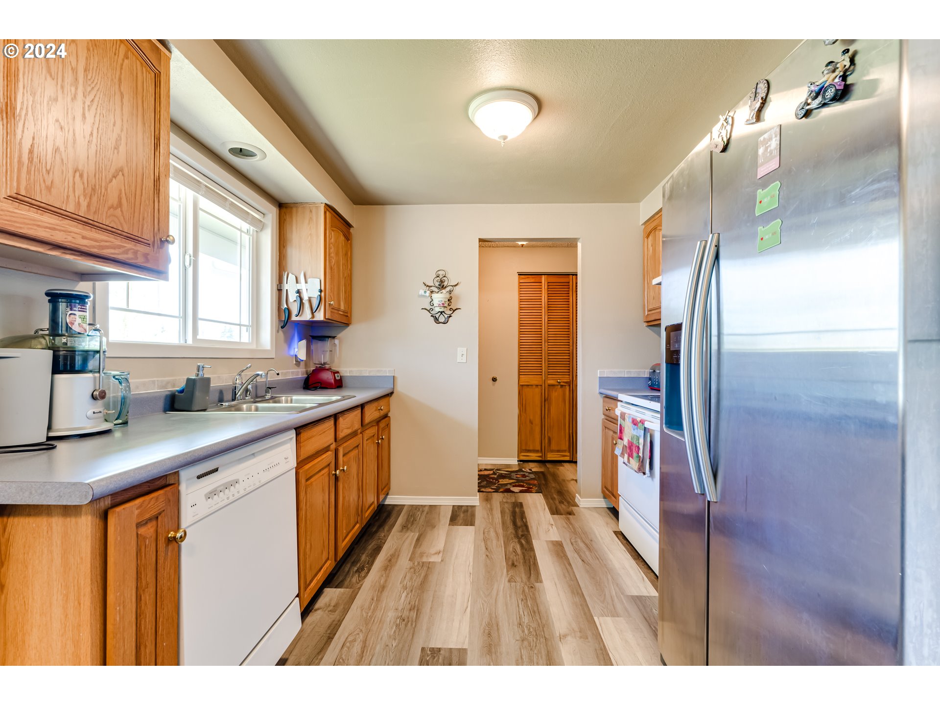 1048 Laurel Avenue Springfield, OR 97478 - Photo 7 of 37 a kitchen with stainless steel appliances granite countertop a sink and cabinets