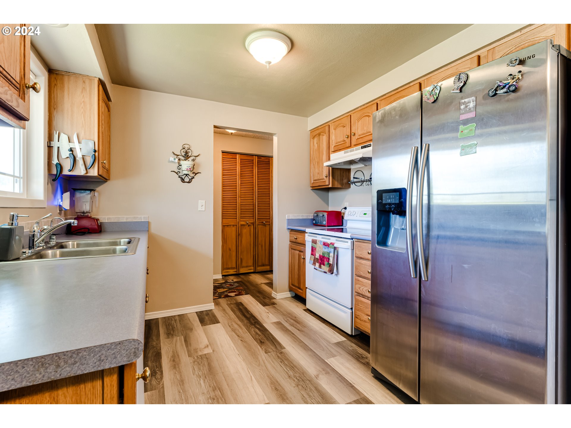 1048 Laurel Avenue Springfield, OR 97478 - Photo 8 of 37 a kitchen with a refrigerator and a stove top oven
