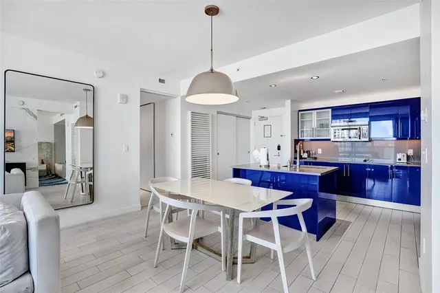 a view of a dining room with furniture wooden floor and chandelier