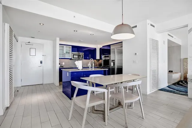 a living room with furniture a flat screen tv and a large window