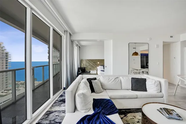 a living room with furniture a rug and a table