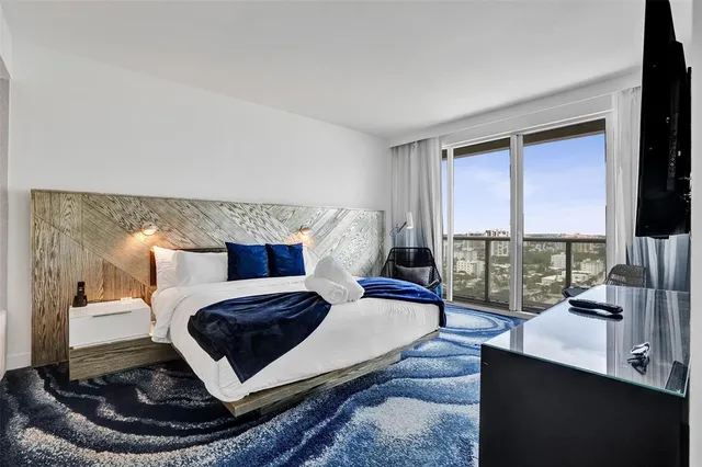 a bedroom with a bed and a desk