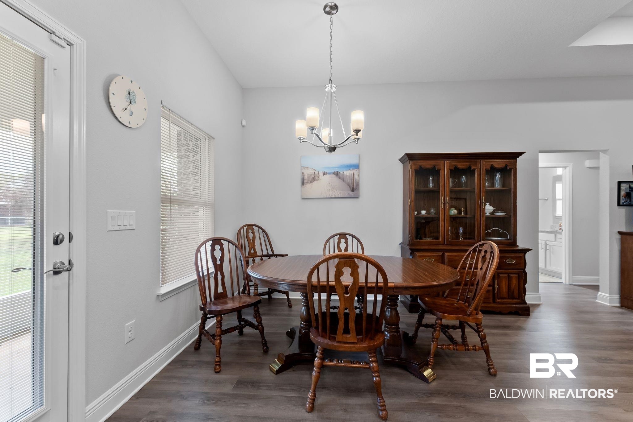 32868 Arbor Ridge Circle Lillian, AL 36549 - Photo 9 of 35 Dining space with dark wood finished floors and a chandelier