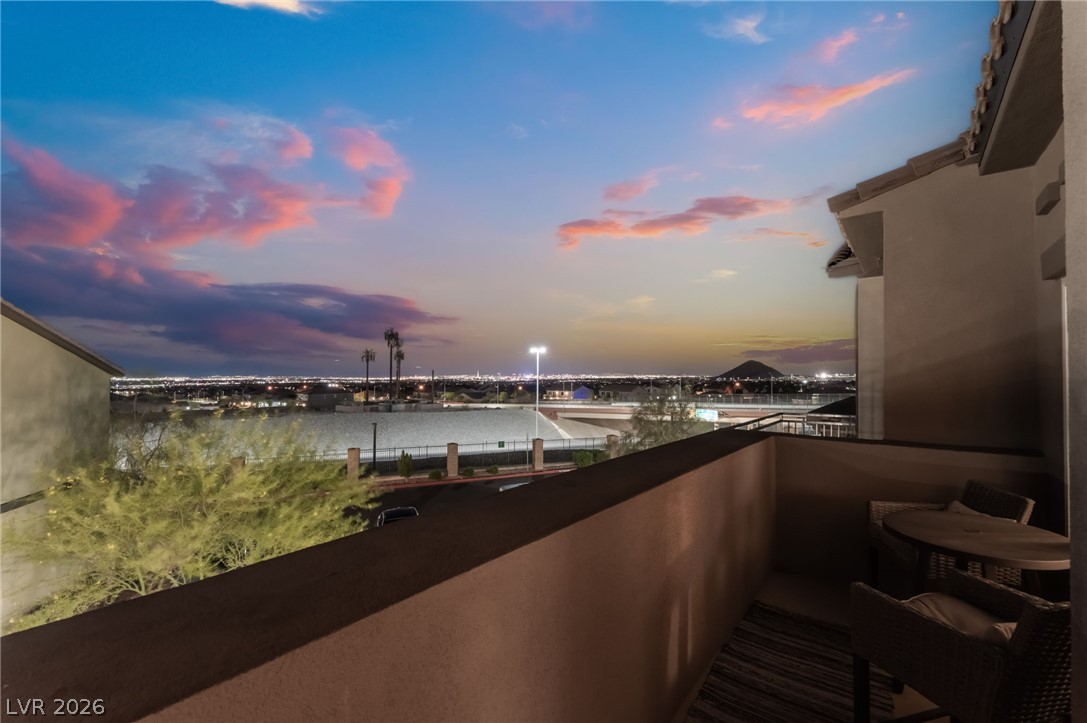 6432 Spring Jog Street Las Vegas, NV 89166 - Photo 61 of 61 City lights stretch beneath a dramatic sunset from this private balcony.