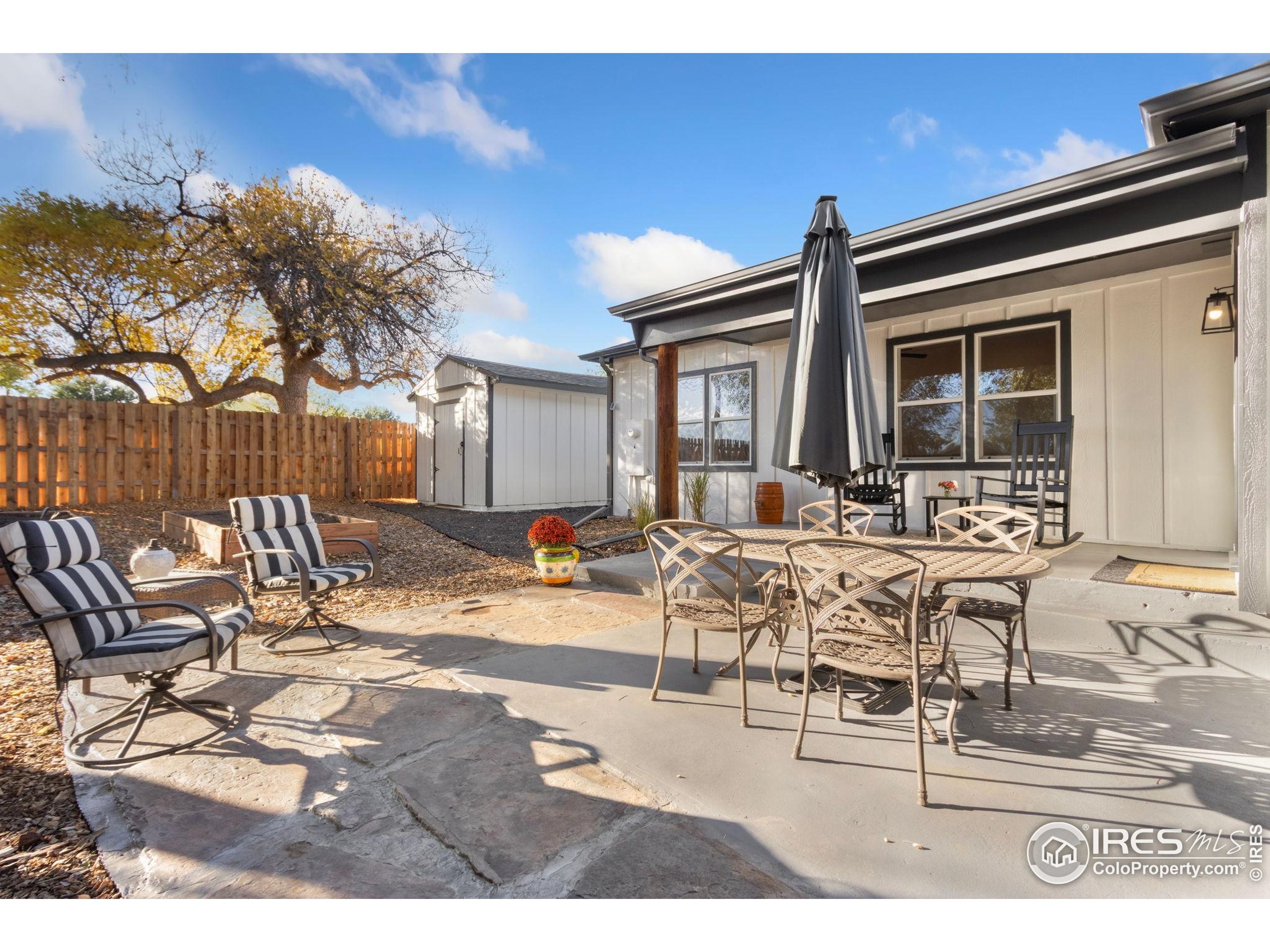437 Clover Lane Fort Collins, CO 80521 - Photo 13 of 22 a view of a dinning table and chairs in patio