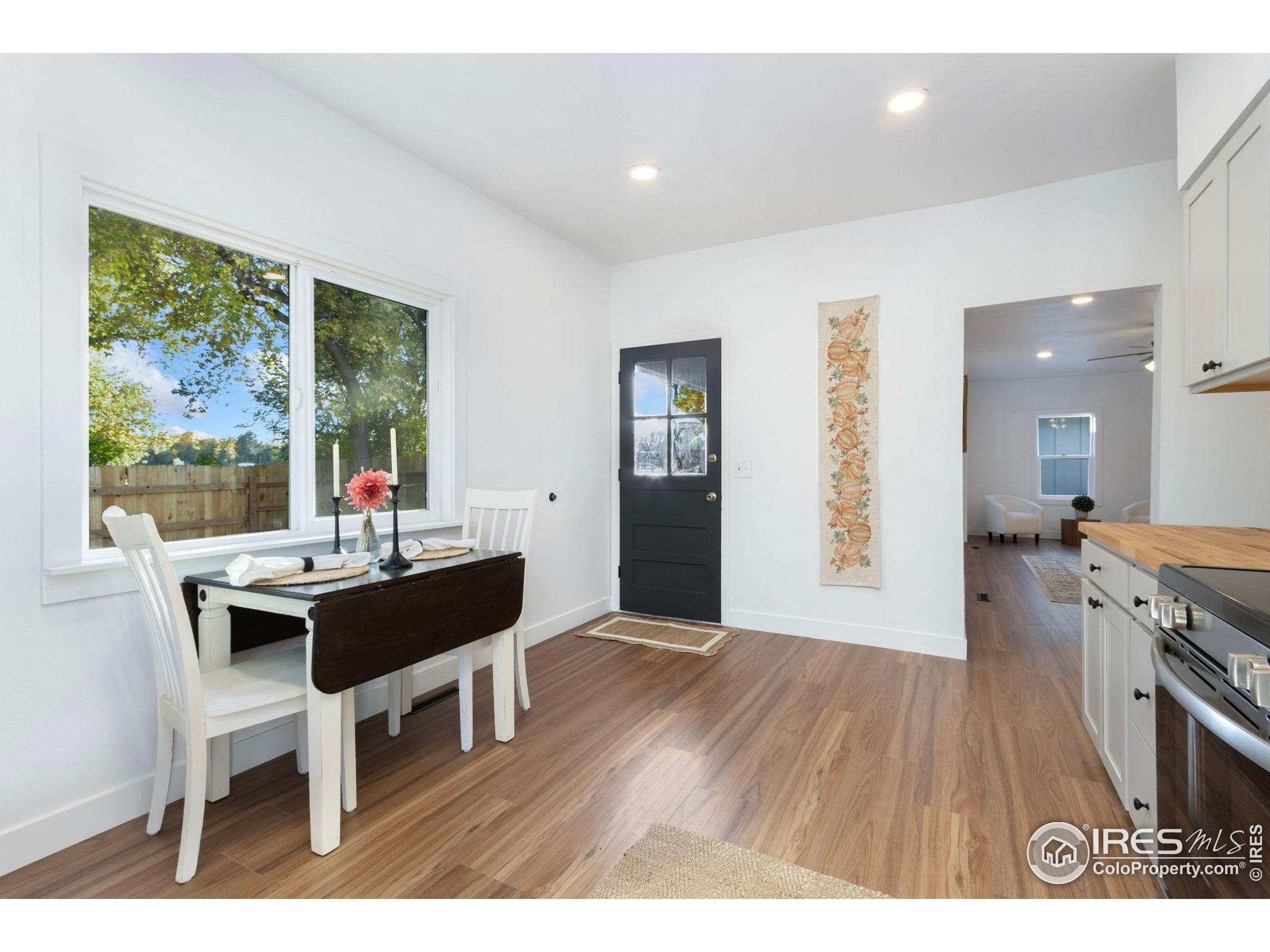 437 Clover Lane Fort Collins, CO 80521 - Photo 3 of 22 a view of a dining room with furniture and wooden floor