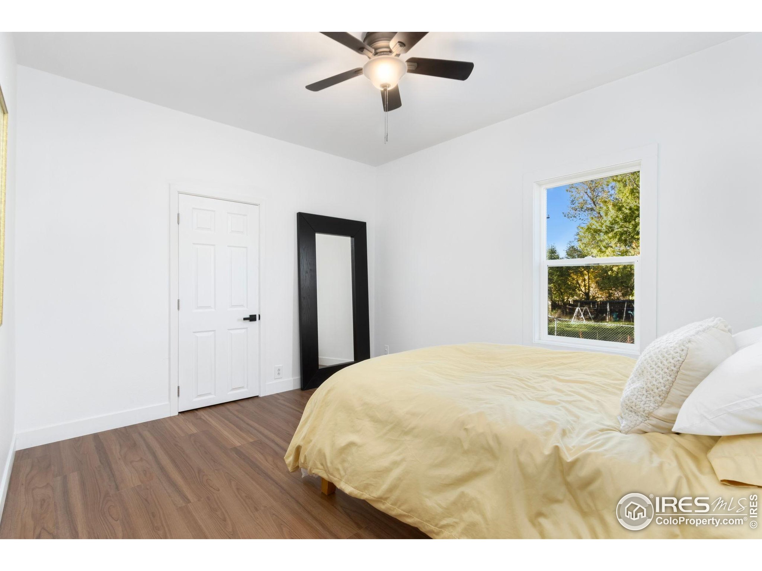 437 Clover Lane Fort Collins, CO 80521 - Photo 6 of 22 a bedroom with a bed and a window