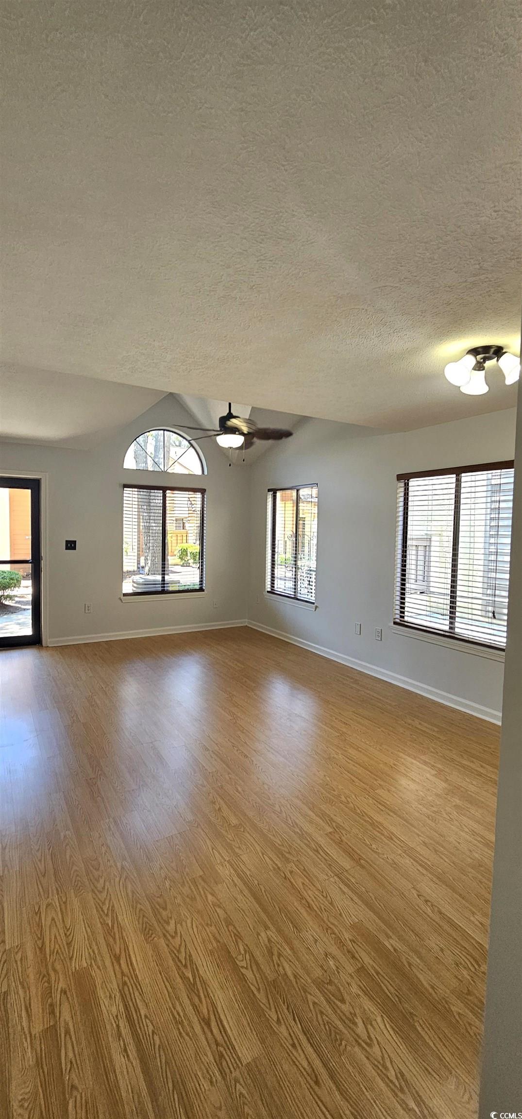 615 13th Avenue South, Unit 137 Surfside Beach, SC 29575 - Photo 13 of 40 Spare room featuring a textured ceiling, light wood-style flooring, and a ceiling fan