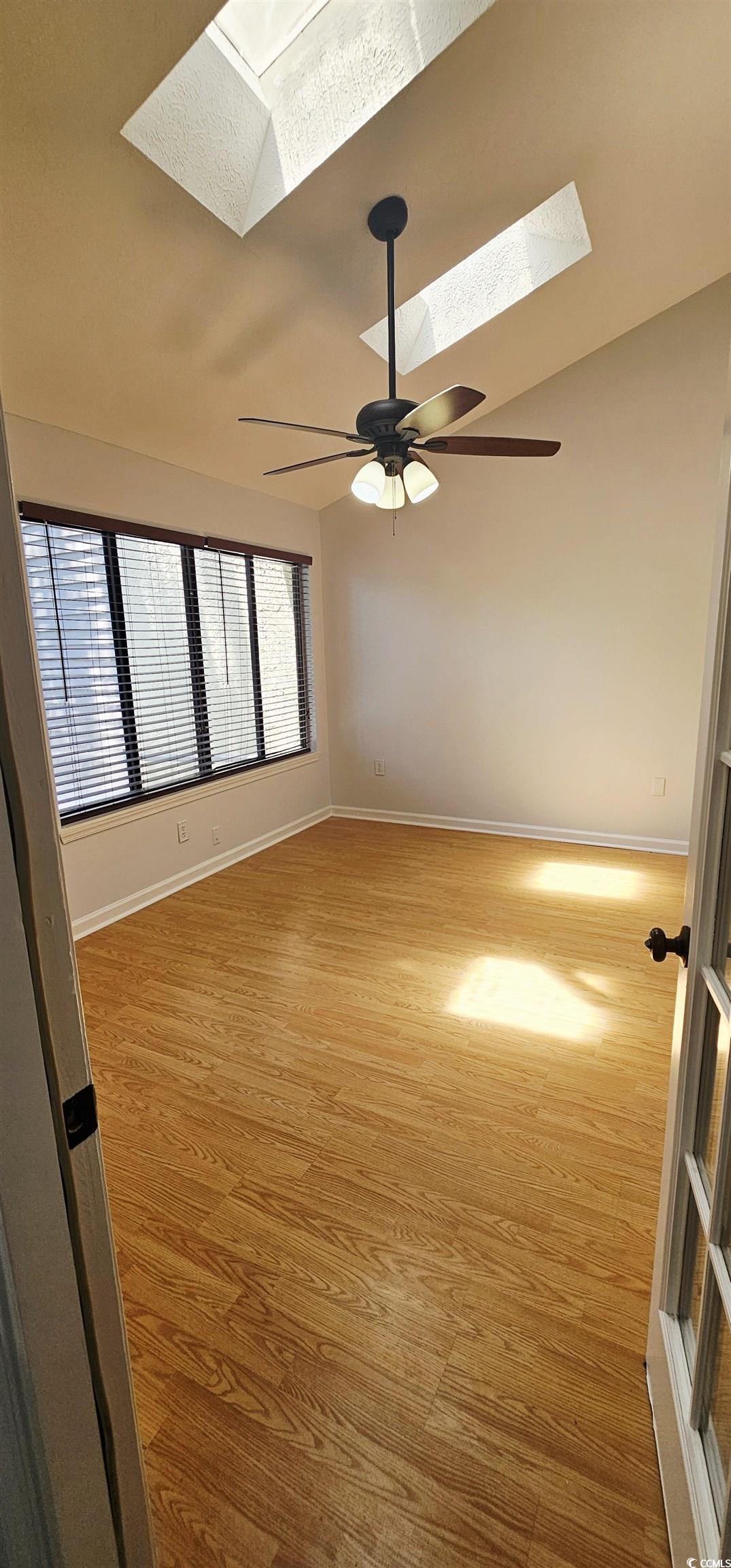 615 13th Avenue South, Unit 137 Surfside Beach, SC 29575 - Photo 17 of 40 Spare room featuring a skylight, light wood-style floors, and lofted ceiling