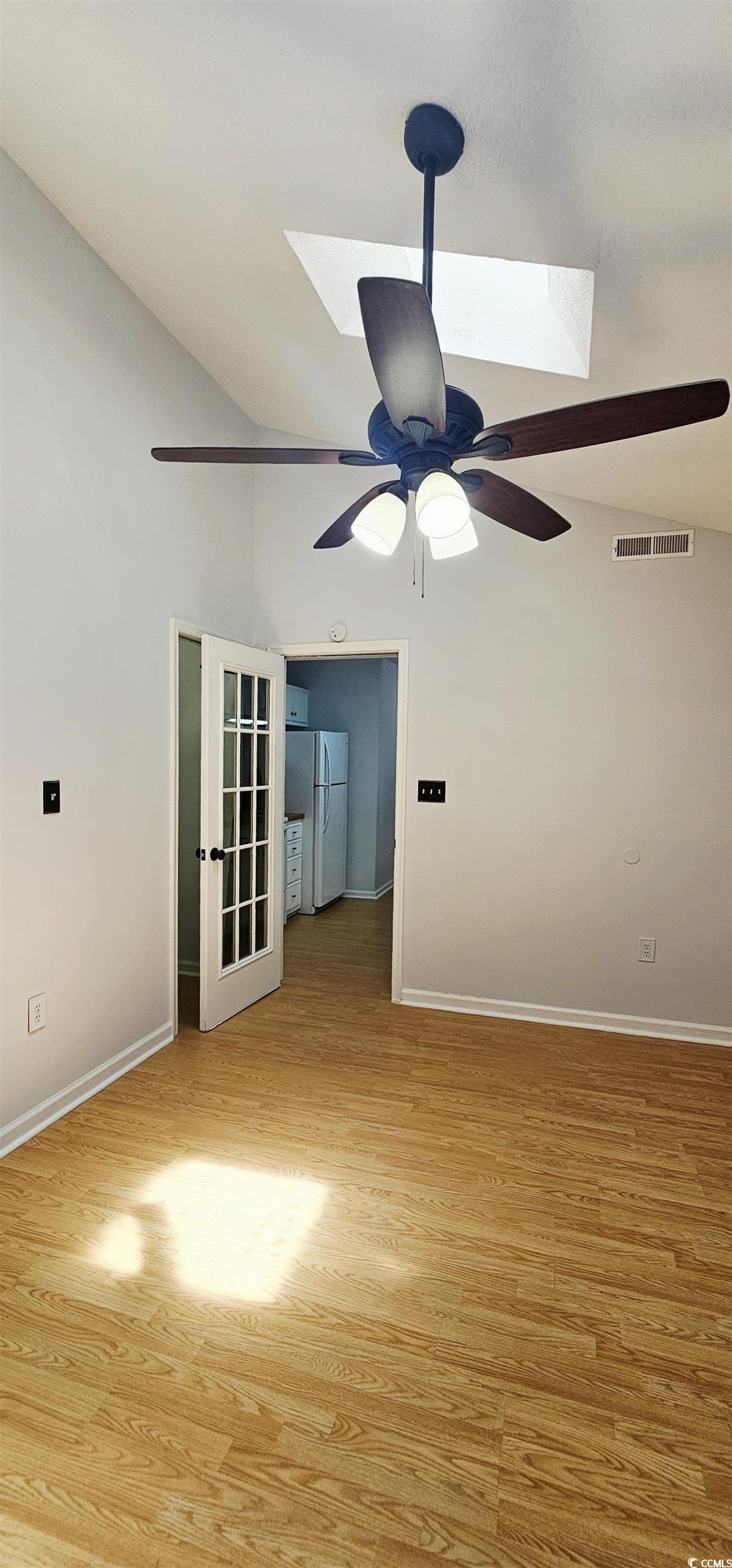 615 13th Avenue South, Unit 137 Surfside Beach, SC 29575 - Photo 19 of 40 Unfurnished room featuring lofted ceiling, a skylight, and light wood-type flooring