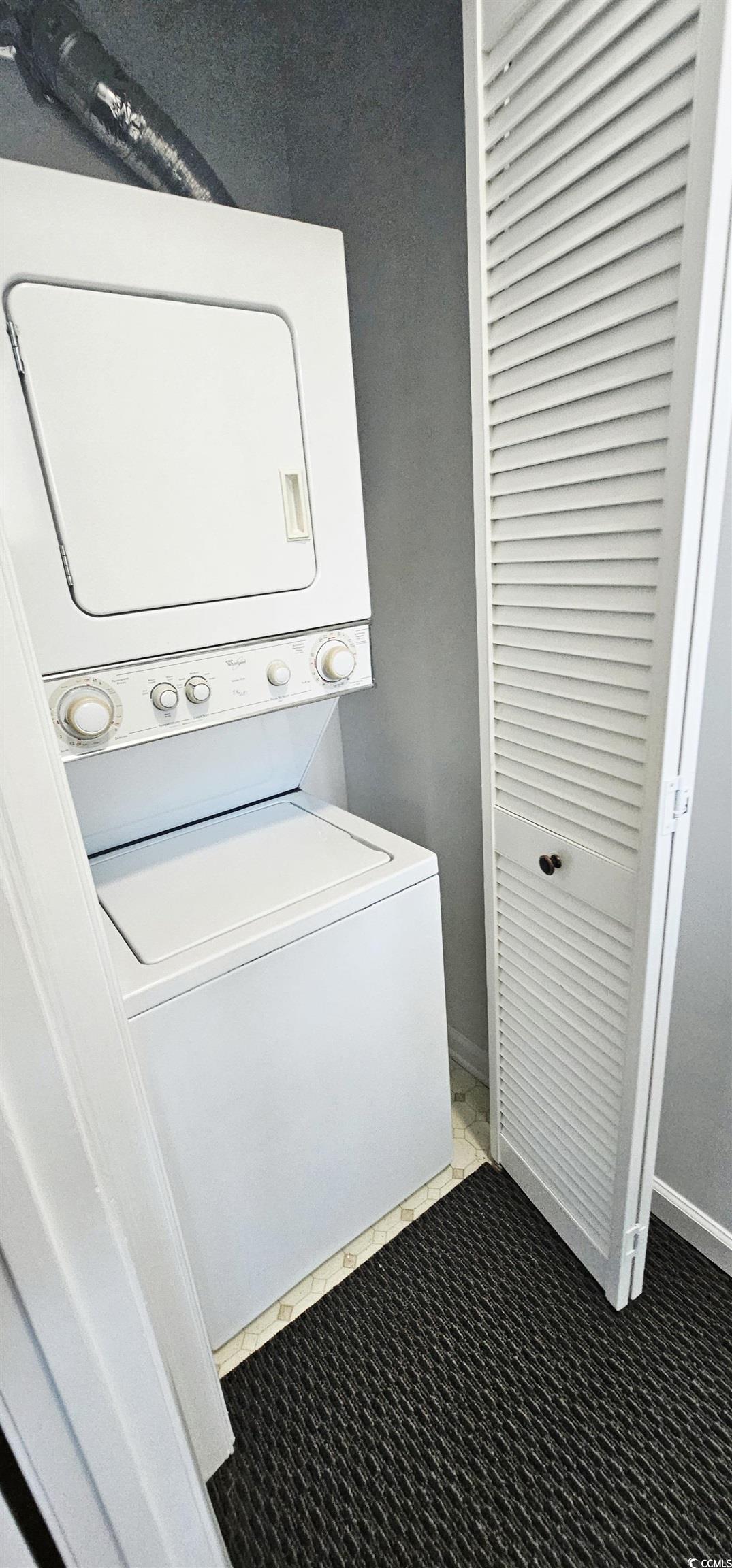 615 13th Avenue South, Unit 137 Surfside Beach, SC 29575 - Photo 24 of 40 Laundry room featuring stacked washer and clothes dryer and dark carpet