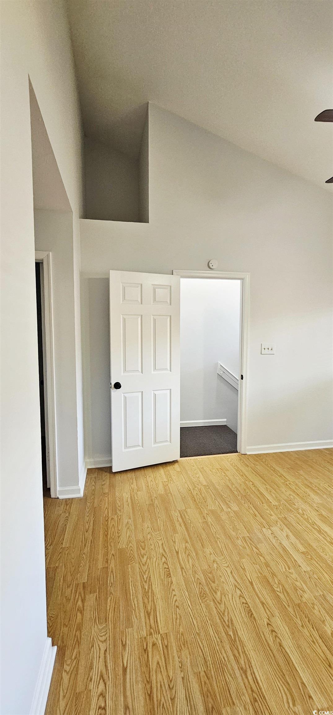 615 13th Avenue South, Unit 137 Surfside Beach, SC 29575 - Photo 27 of 40 Unfurnished bedroom featuring wood finished floors and high vaulted ceiling