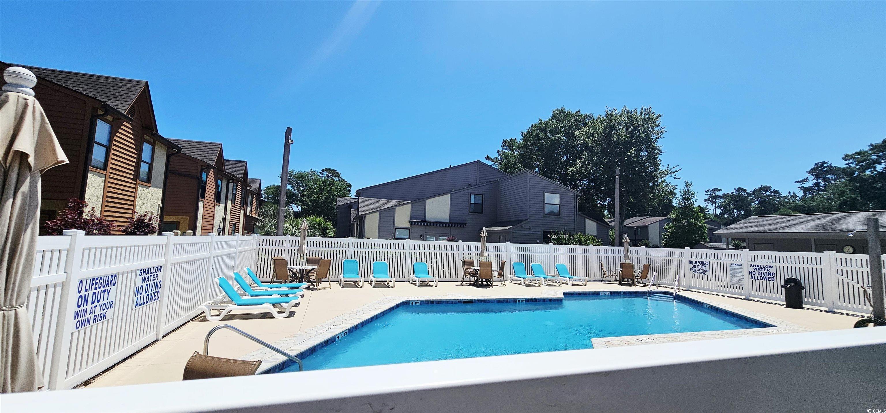 615 13th Avenue South, Unit 137 Surfside Beach, SC 29575 - Photo 39 of 40 Community pool with a residential view, a patio, and a fenced backyard