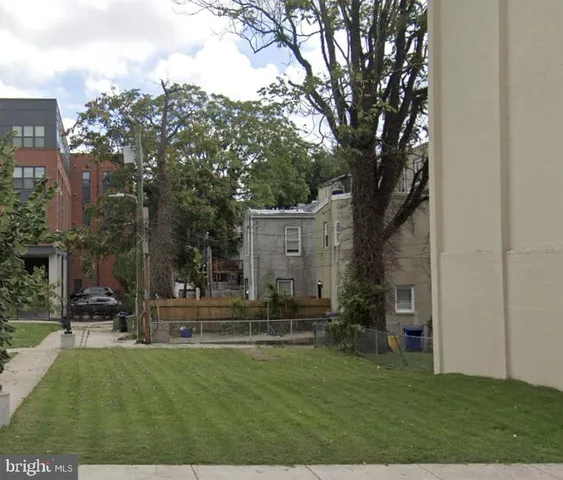 a view of a park that has large trees