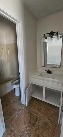 a view of bathroom with a sink and mirror