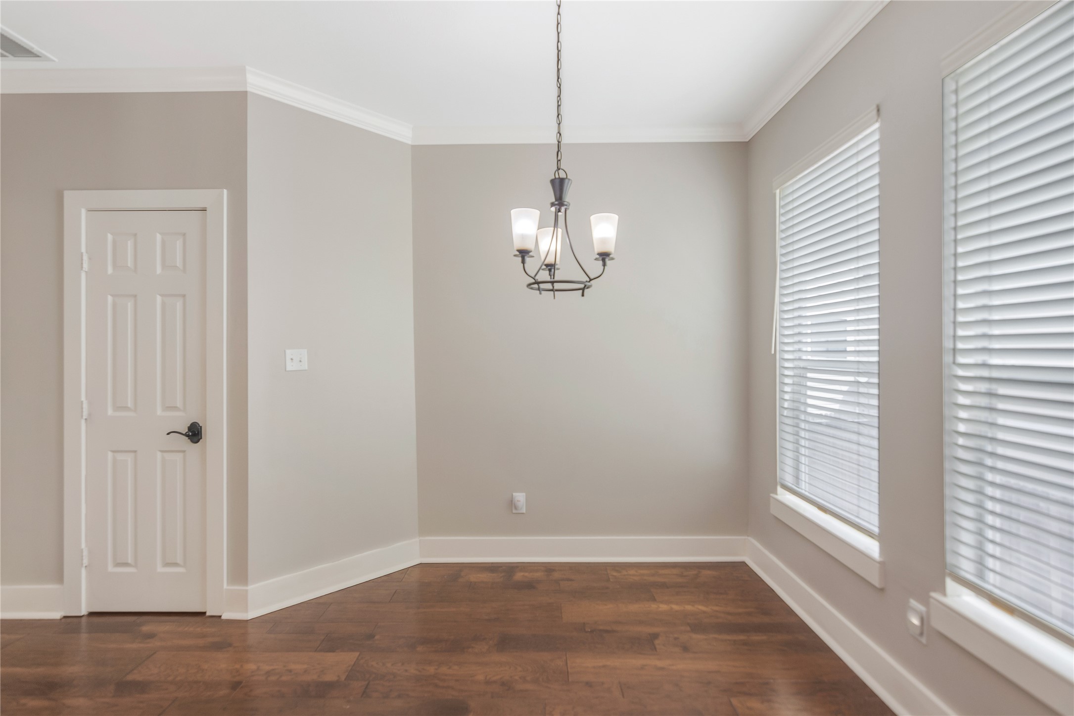 1207 Nagle Street Houston, TX 77003 - Photo 16 of 26 Breakfast area with a modern and simple chandelier. The door leads to the pantry storage area.