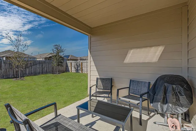 a view of a chairs and table in patio