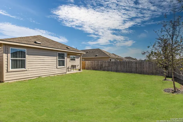 a view of a house with a backyard