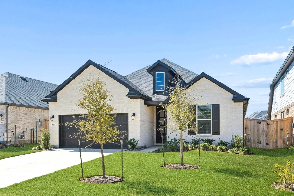 16022 Tangled Vine Lane Conroe, TX 77302 - Photo 2 of 30 a view of a house with a yard and a garden