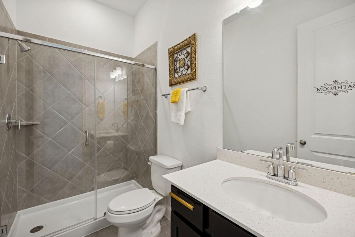 16022 Tangled Vine Lane Conroe, TX 77302 - Photo 22 of 30 a bathroom with a sink toilet and shower
