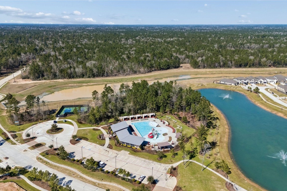 16022 Tangled Vine Lane Conroe, TX 77302 - Photo 25 of 30 a view of a swimming pool with a yard