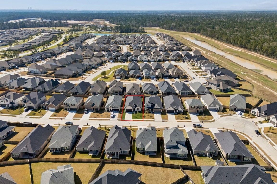 16022 Tangled Vine Lane Conroe, TX 77302 - Photo 28 of 30 an aerial view of residential houses with outdoor space