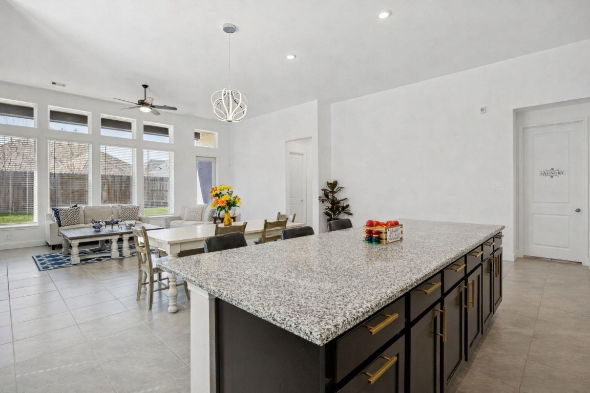 16022 Tangled Vine Lane Conroe, TX 77302 - Photo 6 of 30 a view of kitchen island wooden floor and dining table