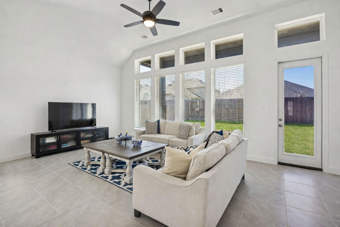 16022 Tangled Vine Lane Conroe, TX 77302 - Photo 10 of 30 a living room with furniture and a flat screen tv