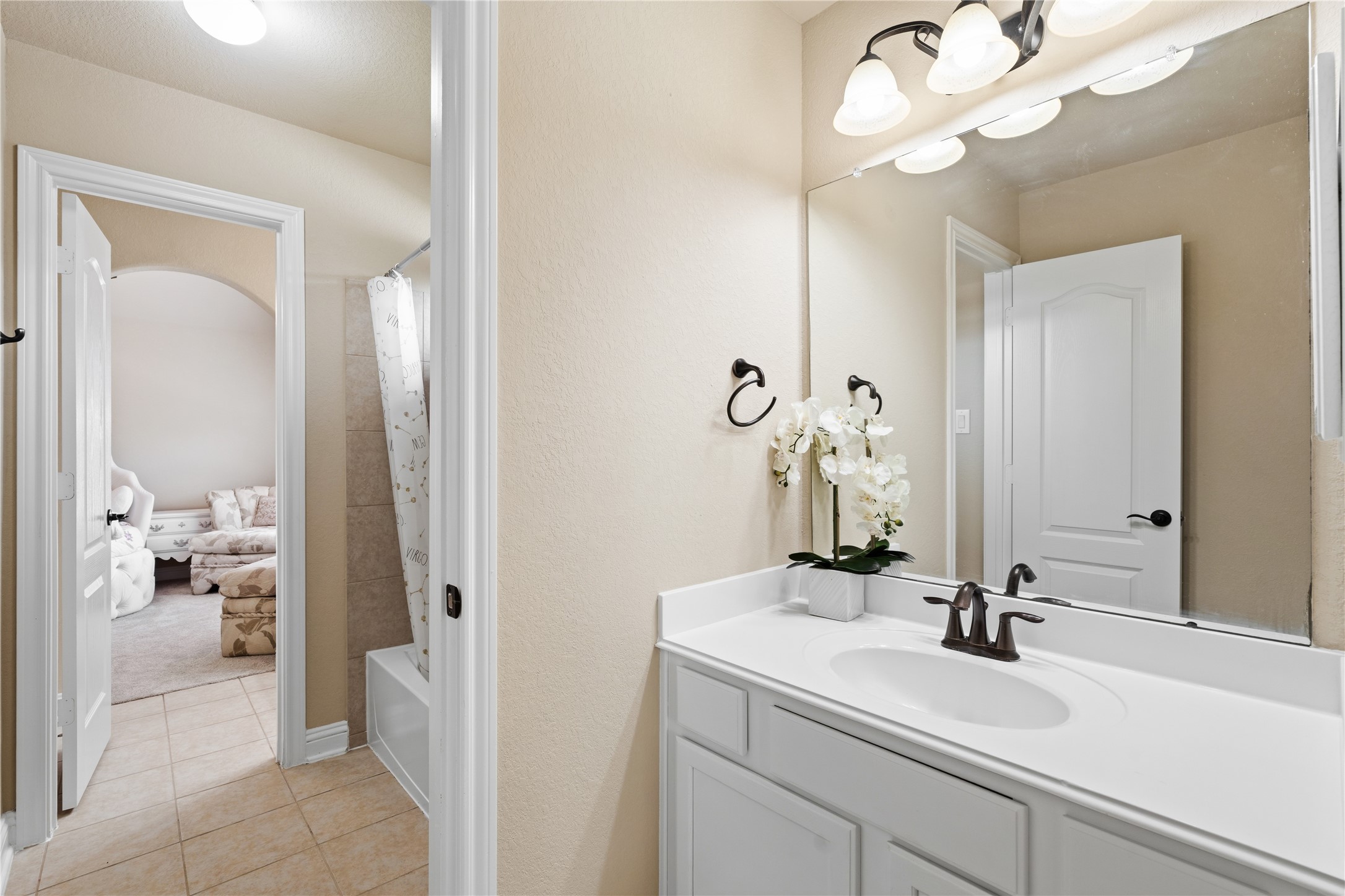 5802 Layton Meadows Lane Spring, TX 77379 - Photo 34 of 42 Secondary bathroom upstairs. Clean white vanity, tub/shower combo with tile surround, white cabinetry.