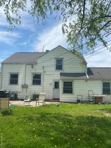 a front view of house with yard and outdoor seating