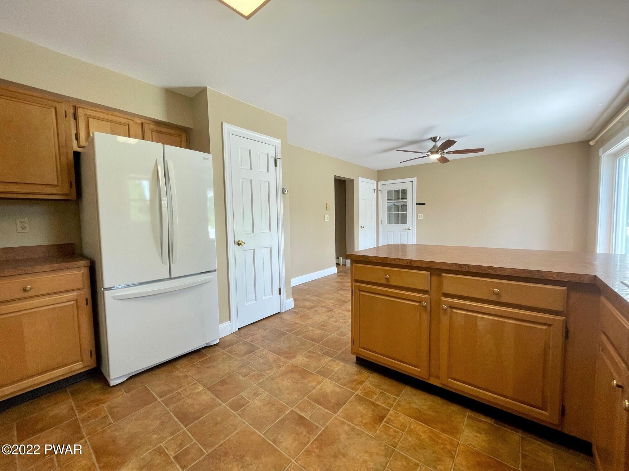 524 Creamton Drive Prompton, PA 18456 - Photo 20 of 57 a kitchen with stainless steel appliances granite countertop a refrigerator a stove and a sink with granite countertops