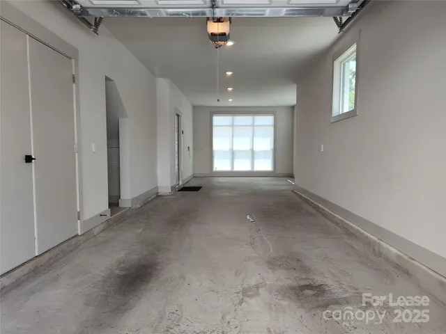 a view of a backyard with couches under an umbrella