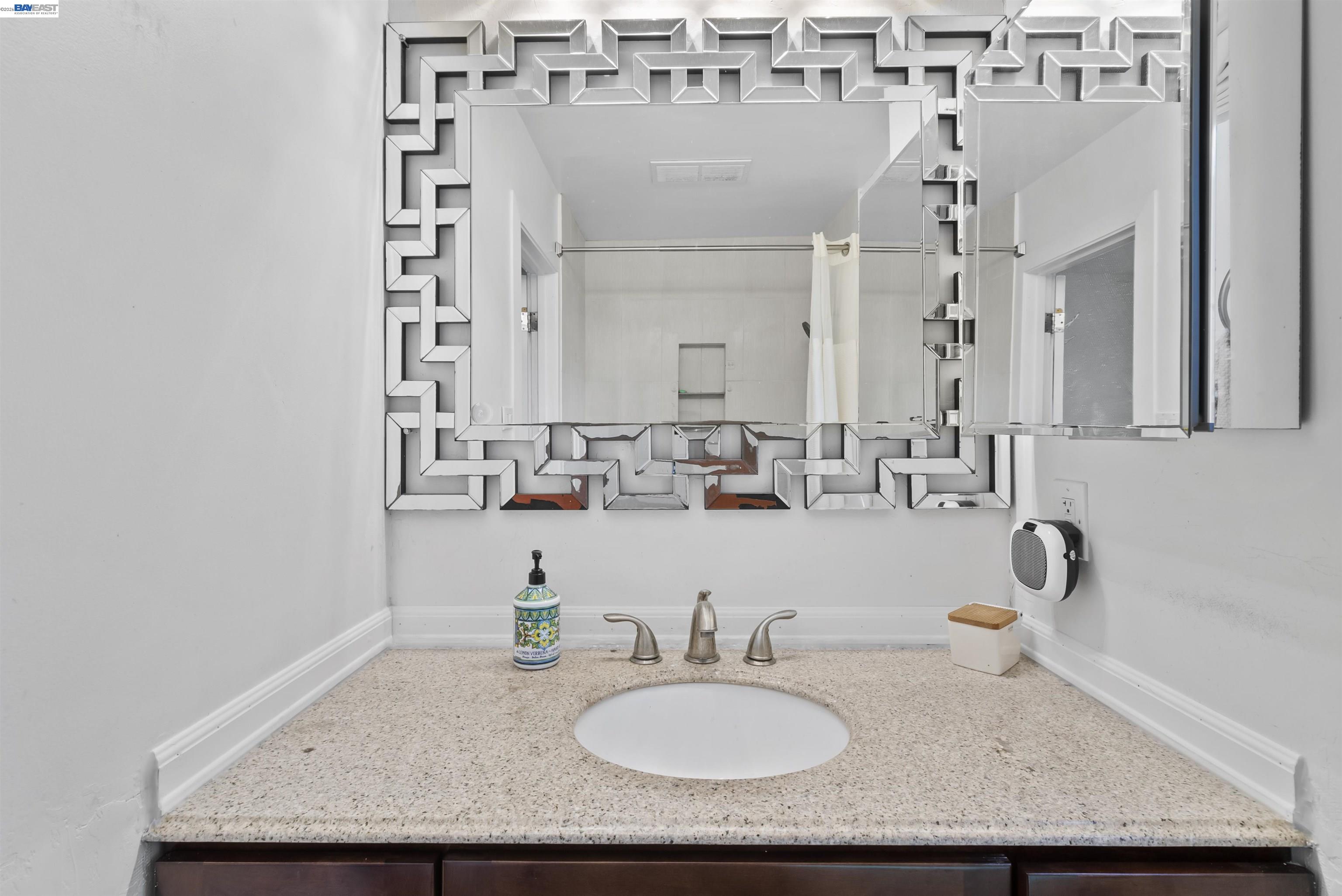 24849 2nd Street Hayward, CA 94541 - Photo 18 of 24 a bathroom with a granite countertop sink and a mirror