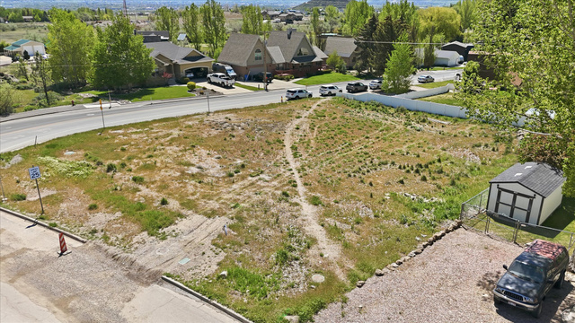 123 West 1050th North, Unit 41 Midway, UT 84049 - Photo 13 of 22 Expansive land parcel featuring existing gravel parking, a storage shed, and a perimeter fence
