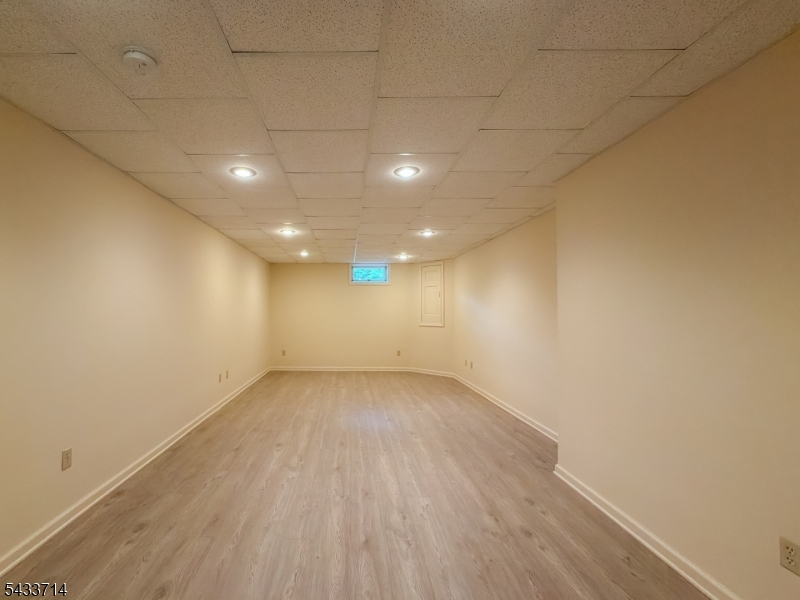 29 Lark Lane Oak Ridge, NJ 07438 - Photo 24 of 26 an empty room with wooden floor and windows